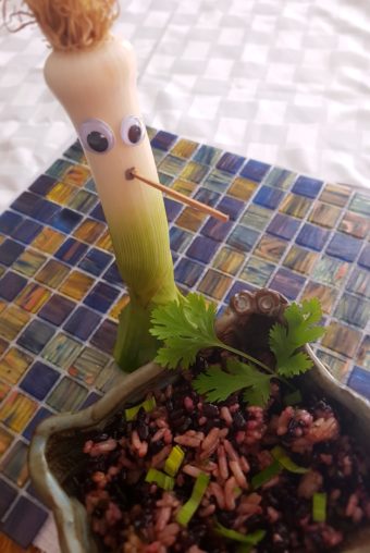 a leek with a tooth pick and googly eyes