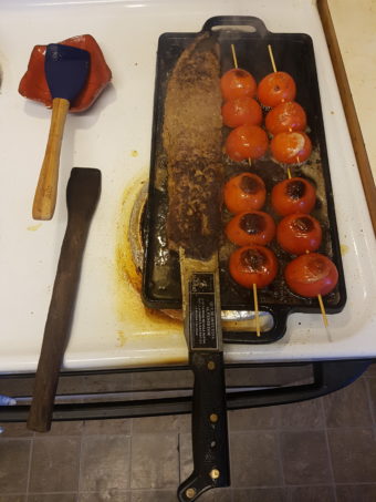 Kabab koobideh on machete with tomatoes