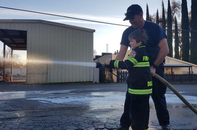 Fireman Duley Sprays a Hose