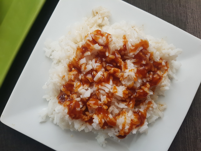 White rice covered in sesame oil and General Tso's sauce